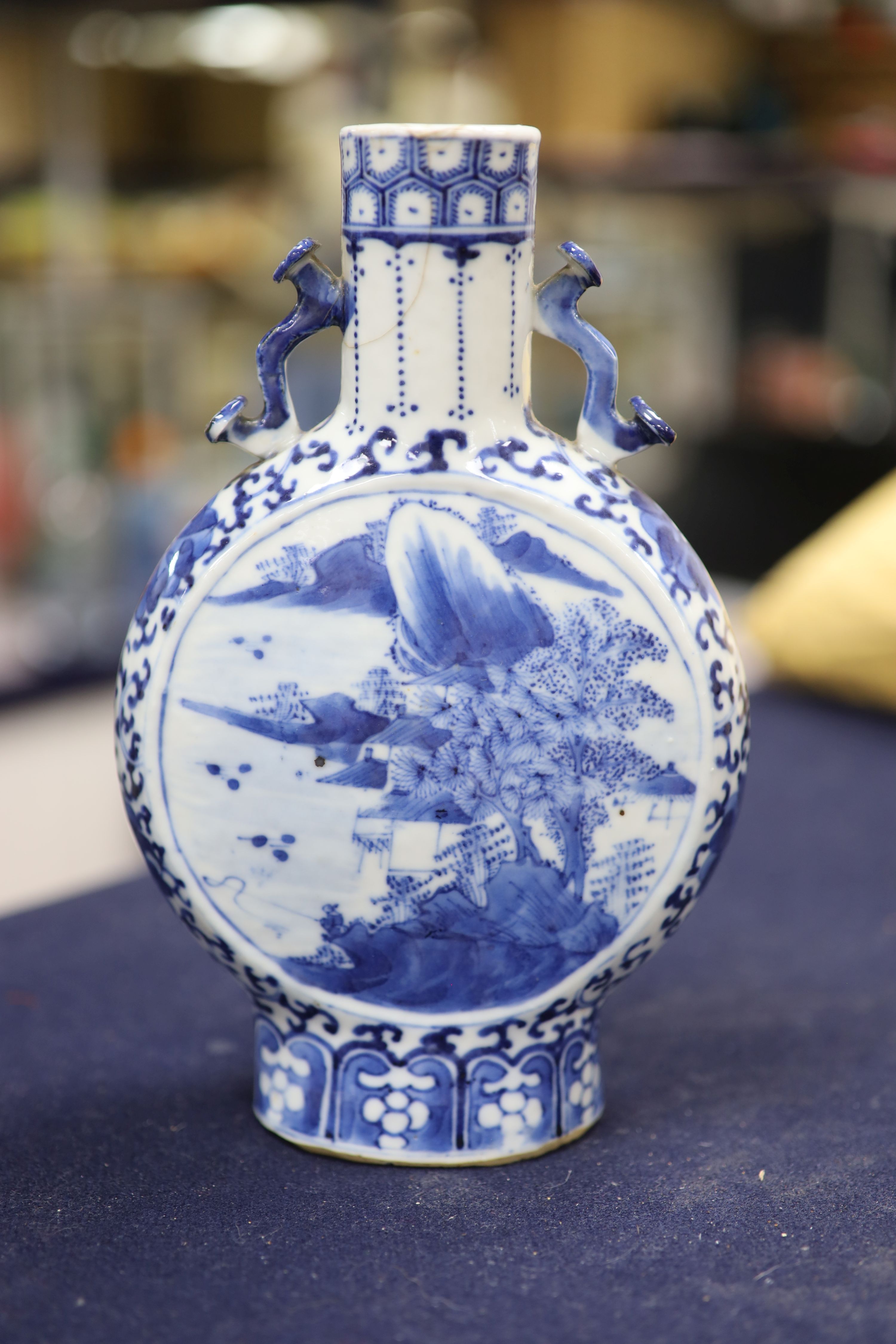 Two 19th century Chinese blue and white moon flasks and a teapot, tallest 21cm